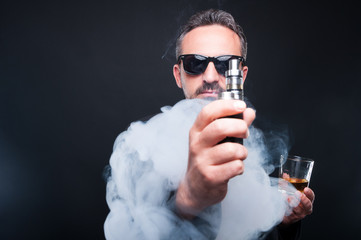 Stylish man with a glass of whiskey