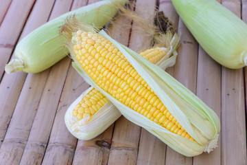 Fresh corn on cobs on rustic wooden