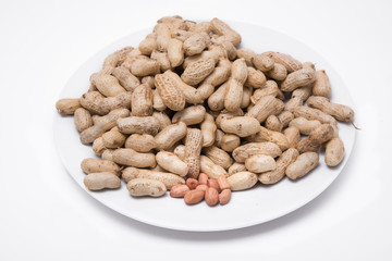 Dried peanuts on white plate at on white background