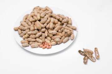 Dried peanuts on white plate at on white background