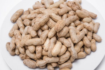 Dried peanuts on white plate at on white background