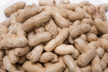 Dried peanuts on white plate at on white background
