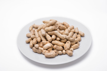 Dried peanuts on white plate at on white background