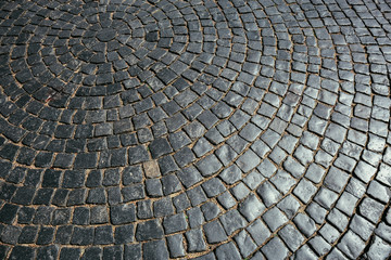 Texture of old stone pavement tiles cobblestones bricks pattern, background