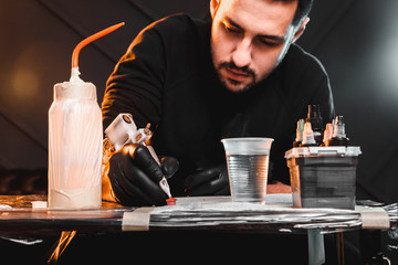 master tattoo artist prepares tools for tattooing