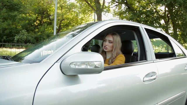 Angry woman driver with road rage yelling at someone