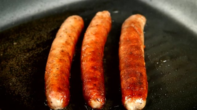 frying sausage in pan