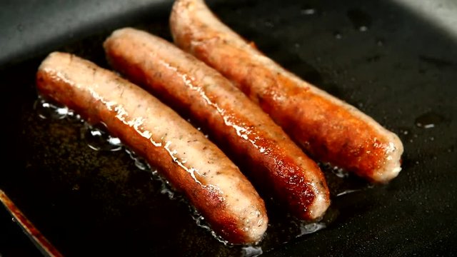frying sausage in pan