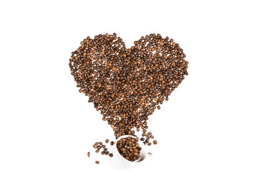 White cup and heart symbol made from coffee seeds isolated on white
