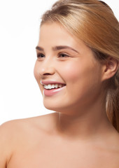 Obraz premium Beautiful girl smiling on white background in studio photo. Perfect white teeth