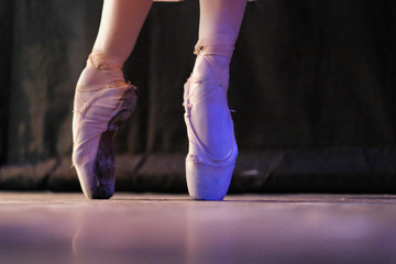 Fototapeta premium The ballerina performs the dance movement at the rehearsal in the theater