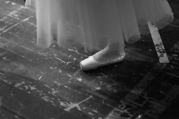 Ballerina in a suit in the rehearsal hall of the theater