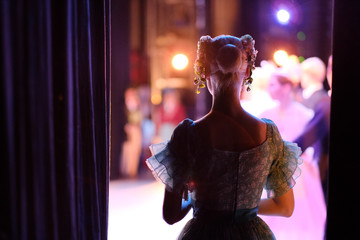 A ballerina awaiting the moment of entering the stage in the play - obrazy, fototapety, plakaty