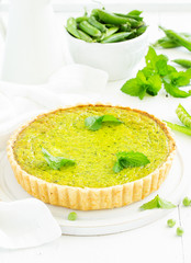 Homemade tart with green peas, bacon and cheese.