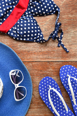Summer hat and sunglasses with accessories and sandals on white background