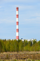 Central white-red heating chimney on thermal power station. Deforestation zone and trees on foreground. - 159288585