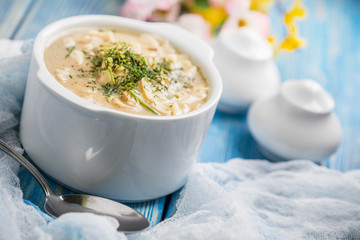 Tasty mushroom soup with noodles on a wooden table.