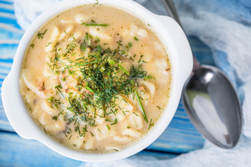 Tasty mushroom soup with noodles on a wooden table.