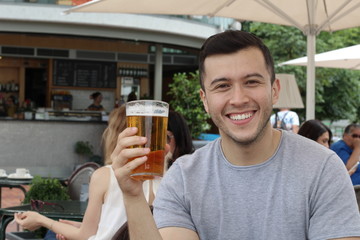 Happy man holding his cold refreshing beer