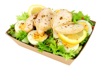 Roast chicken and egg salad meal in a cardboard take away tray isolated on a white background