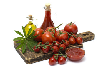 olive oil with ketchup and tomatoes on a wooden board. 
