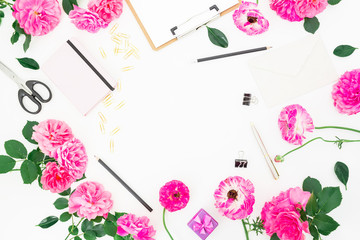 Obraz premium Minimalistic stylish frame workspace with clipboard, notebook, pink flowers and accessories on white background. Flat lay, top view.