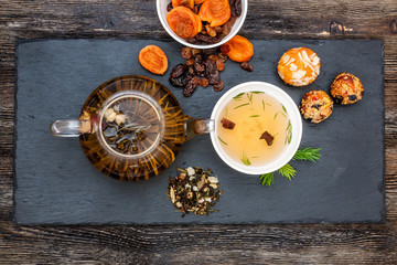 Green tea with cake, dried fruits and chocolate
