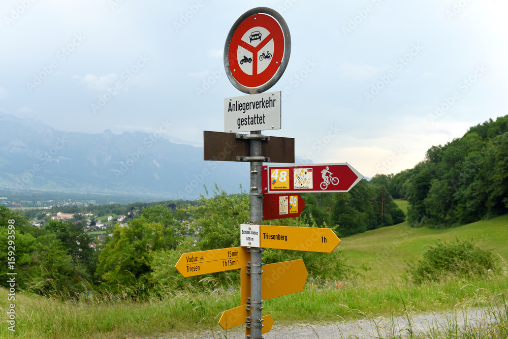 Wall mural Vaduz, Liechtenstein - June 02, 2017: Signs on the road near Gutenberg Castle in Vaduz, Liechtenstein.