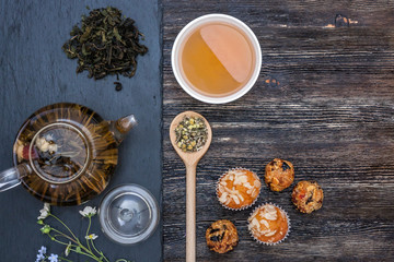 Green tea with cake, dried fruits and chocolate