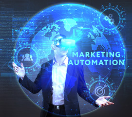 The concept of business, technology, the Internet and the network. A young entrepreneur working on a virtual screen of the future and sees the inscription: Marketing automation