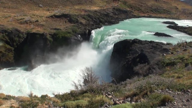 Rapids of mountain river show power water in Patagonia Argentina. Unique landscape of wildlife. Beautiful nature background. Travel and tourism in picturesque world of stone rocks and hills.