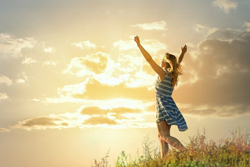 Happy young woman on blue sky background