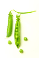 Pea pod and pea seeds on white