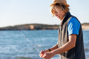 Teenage boy fishing at sea