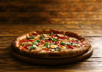 Tasty pizza on wooden table