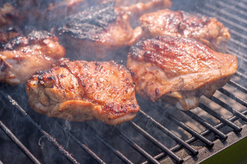Grilled chicken thigh on the grill