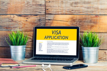Visa Application in a laptop computer in a workplace.