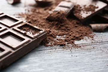 Dark chocolate pieces on wooden table