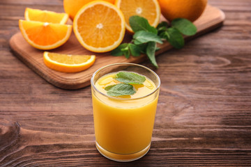 Orange juice with mint and fresh fruit on kitchen table
