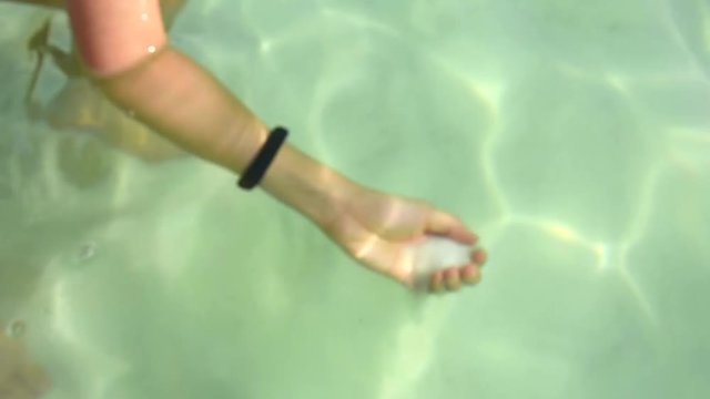 a woman grabbed a sea salt underneath the Dead Sea