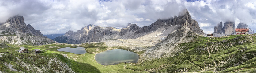 Fototapeta na wymiar Panoramic view of lake and mountain on a cloudy day, Italian Dolomites
