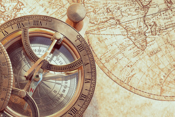 Naklejka na ściany i meble Old compass over ancient map