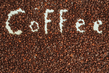 Fototapeta na wymiar The words coffee written against scattered natural coffee