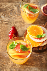 Two glasses of fresh citrus cocktail on table