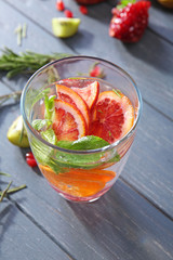 Glass with fresh citrus cocktail on table