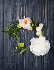 peony flowers arrangement on old wooden board background. Festiv