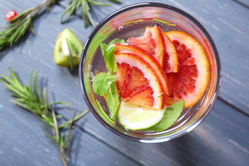 Glass with fresh citrus cocktail on table