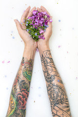 Girl's hands with tattoos and flowers