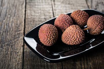 Lychees fruits on wooden background