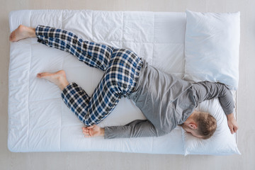 Nice adult man sleeping on his belly